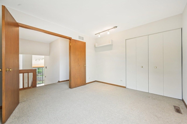 397 Briarwood Ct, Gurnee, IL 60031 - unfurnished bedroom with light carpet, a closet, and track lighting