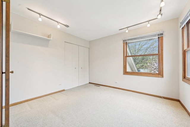 397 Briarwood Ct, Gurnee, IL 60031 - unfurnished bedroom featuring rail lighting, carpet, and a closet