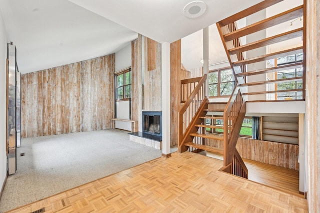397 Briarwood Ct, Gurnee, IL 60031 - unfurnished living room with wood walls, a large fireplace, and stairway