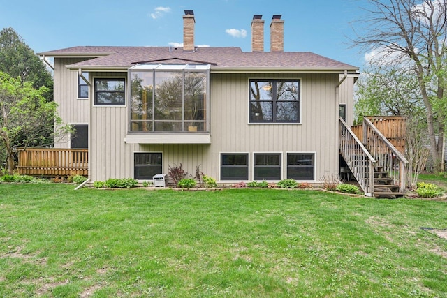 397 Briarwood Ct, Gurnee, IL 60031 - rear view of property featuring a chimney, a deck, stairway, a lawn, and roof with shingles