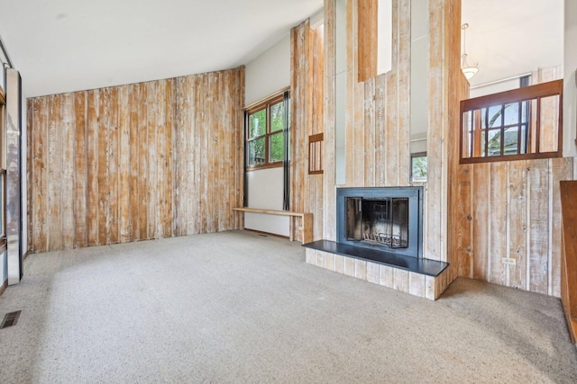 397 Briarwood Ct, Gurnee, IL 60031 - unfurnished living room with wooden walls, a fireplace with raised hearth, and carpet flooring