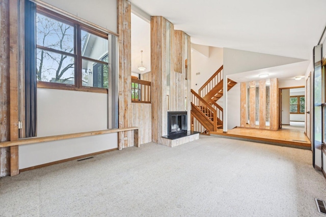 397 Briarwood Ct, Gurnee, IL 60031 - unfurnished living room featuring stairs, a fireplace with raised hearth, lofted ceiling, and carpet