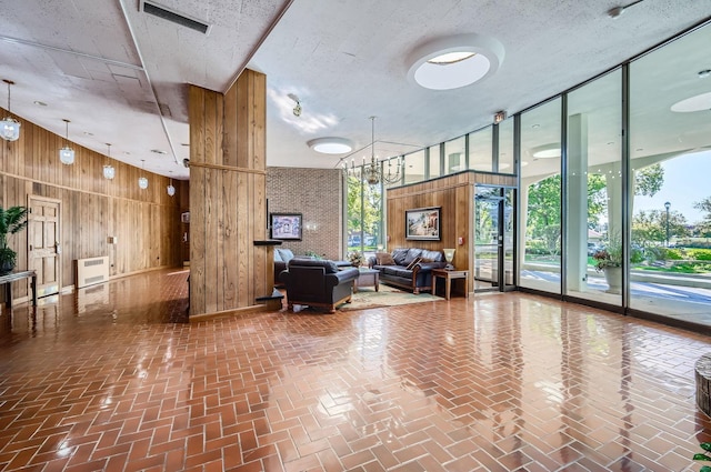 20 N Tower Rd Unit 12M, Oak Brook, IL 60523 - lobby featuring wood walls, expansive windows, and a towering ceiling