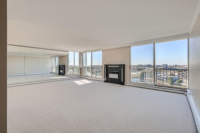 20 N Tower Rd Unit 12M, Oak Brook, IL 60523 - unfurnished living room with carpet flooring, expansive windows, a baseboard radiator, and a glass covered fireplace