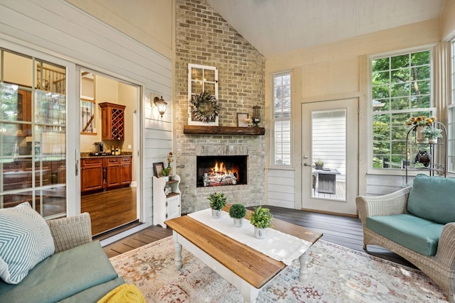 5803 Tomlinson Dr, Mchenry, IL 60050 - living area with lofted ceiling, wood-type flooring, and a large fireplace