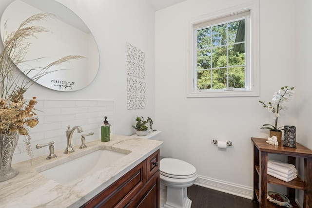 5803 Tomlinson Dr, Mchenry, IL 60050 - half bath featuring vanity, wood finished floors, and backsplash