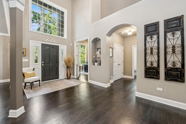 5803 Tomlinson Dr, Mchenry, IL 60050 - foyer entrance with dark wood-type flooring, a high ceiling, and arched walkways