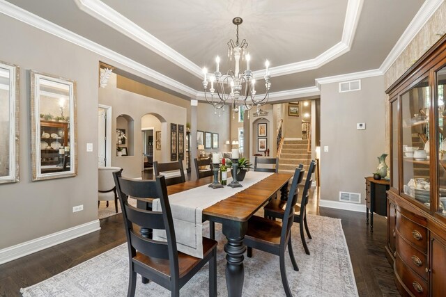 5803 Tomlinson Dr, Mchenry, IL 60050 - dining room featuring a raised ceiling, arched walkways, a chandelier, stairs, and crown molding