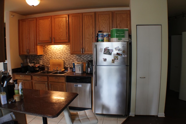125 S Jefferson St Unit 1207, Chicago, IL 60661 - kitchen with appliances with stainless steel finishes, brown cabinetry, dark countertops, and decorative backsplash