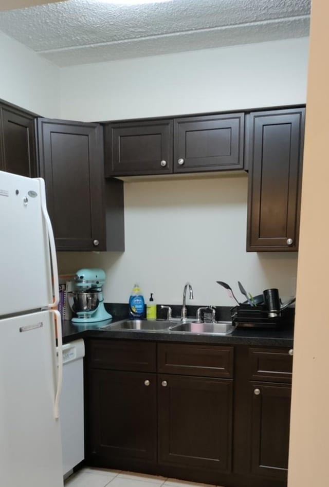 100 W Park Circle Dr Unit 1C, Wheaton, IL 60187 - kitchen with white appliances, dark countertops, light tile patterned flooring, a textured ceiling, and dark brown cabinetry