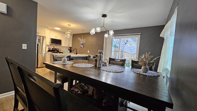 16 Forest Ln, Cary, IL 60013 - dining area with light wood-type flooring and a chandelier