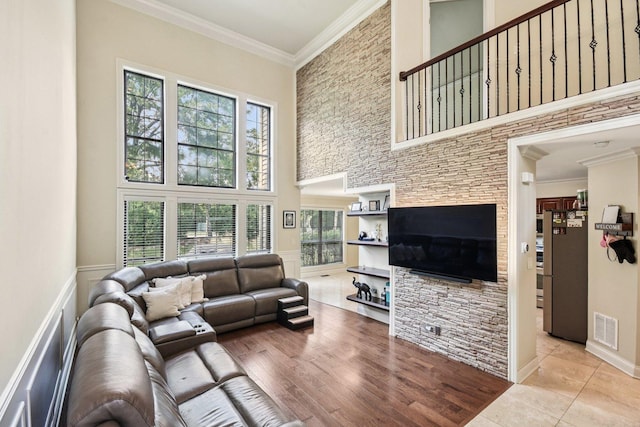 145 Benton Ln, Bloomingdale, IL 60108 - living area with a high ceiling, crown molding, and wainscoting