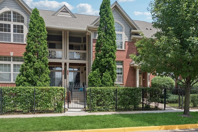 8471 Callie Ave, Morton Grove, IL 60053 - view of front of property with brick siding, a balcony, roof with shingles, and a gate