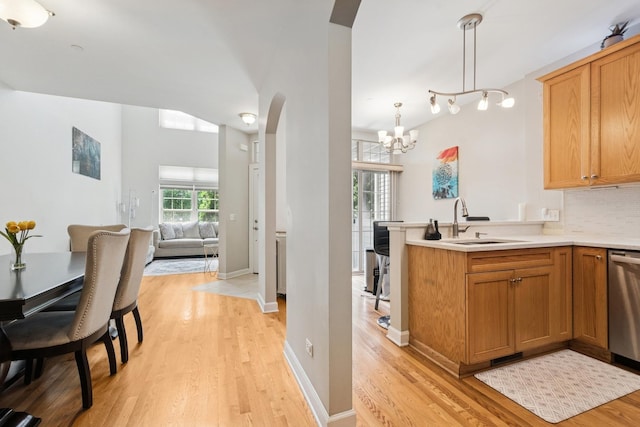 8471 Callie Ave, Morton Grove, IL 60053 - kitchen with dishwasher, light wood-style floors, open floor plan, arched walkways, and tasteful backsplash