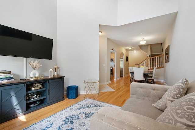 8471 Callie Ave, Morton Grove, IL 60053 - living area with arched walkways, light wood-type flooring, and stairway