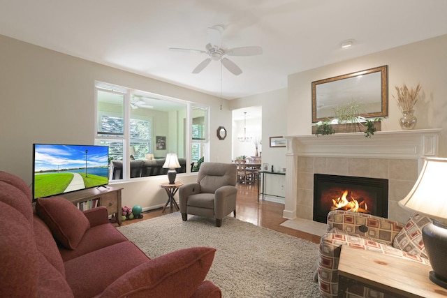 13159 Shirley Ln, Huntley, IL 60142 - living room featuring a tiled fireplace, a ceiling fan, and wood finished floors