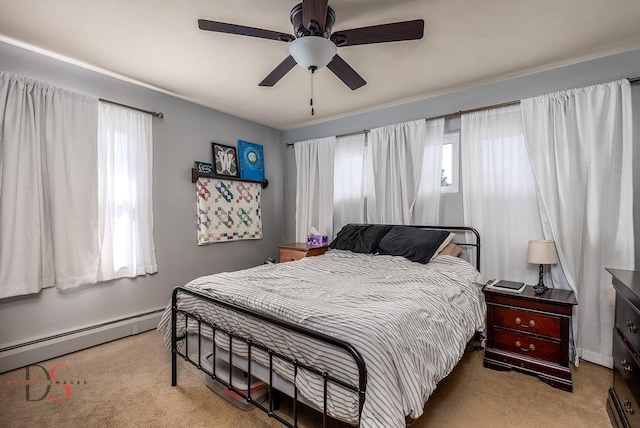 927 Clark St, Marseilles, IL 61341 - carpeted bedroom featuring multiple windows, a baseboard radiator, and a ceiling fan