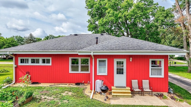927 Clark St, Marseilles, IL 61341 - back of house featuring entry steps, a shingled roof, and a lawn