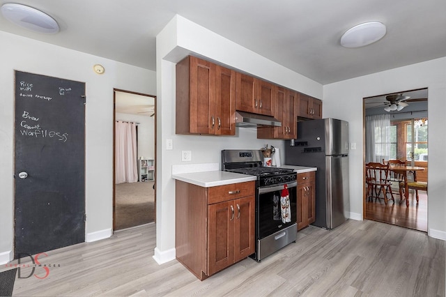 927 Clark St, Marseilles, IL 61341 - kitchen with stainless steel appliances, extractor fan, light countertops, light wood-type flooring, and a ceiling fan