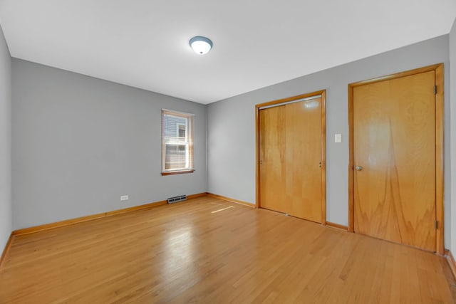 2621 Ridge Rd, Lansing, IL 60438 - unfurnished bedroom with light wood finished floors and a closet