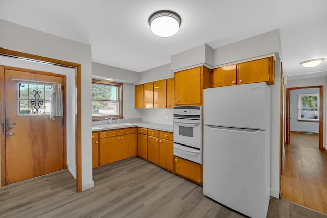 2621 Ridge Rd, Lansing, IL 60438 - kitchen featuring white appliances, a warming drawer, light wood-type flooring, and light countertops