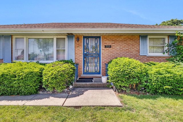 7859 78th St, Bridgeview, IL 60455 - property entrance featuring brick siding and a shingled roof