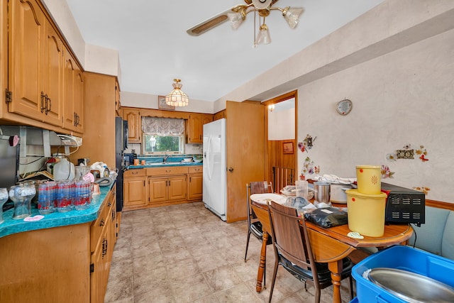 7859 78th St, Bridgeview, IL 60455 - kitchen with white fridge with ice dispenser, freestanding refrigerator, ceiling fan, brown cabinetry, and dark countertops