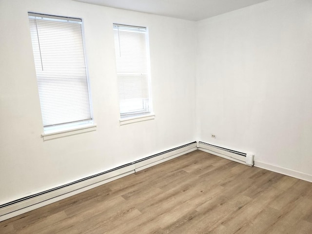 543 E 60th St Unit 1, Chicago, IL 60637 - unfurnished room with wood finished floors and baseboard heating
