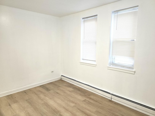 543 E 60th St Unit 1, Chicago, IL 60637 - spare room with baseboard heating and light wood-style flooring