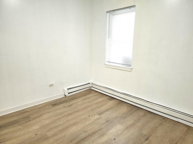 543 E 60th St Unit 1, Chicago, IL 60637 - unfurnished room featuring wood finished floors, a baseboard heating unit, and healthy amount of natural light