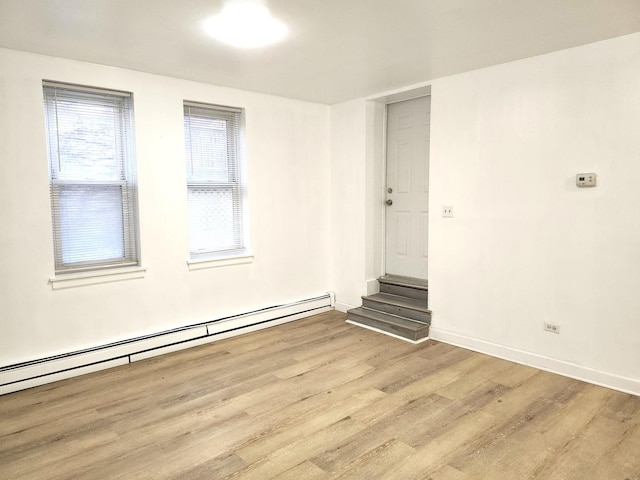 543 E 60th St Unit 1, Chicago, IL 60637 - spare room with light wood-style floors and a baseboard radiator