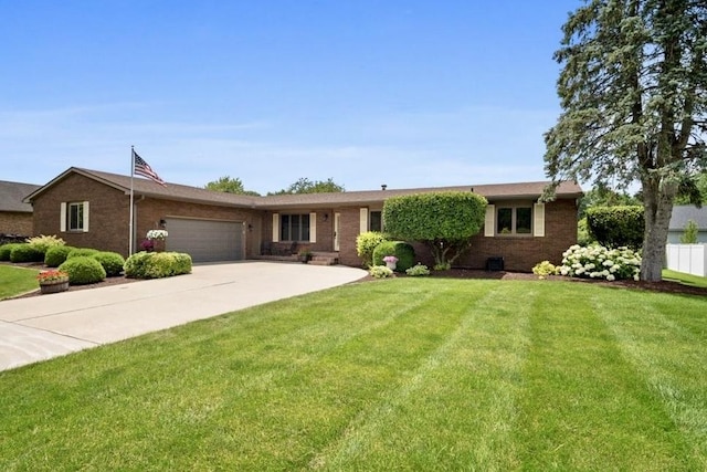 2210 Hedgewood Dr, Bloomington, IL 61704 - ranch-style home with an attached garage, brick siding, a front yard, and concrete driveway