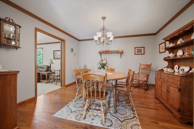 2210 Hedgewood Dr, Bloomington, IL 61704 - dining room with light wood-type flooring, ornamental molding, a chandelier, and a textured ceiling