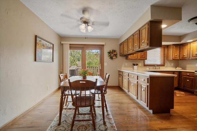 2210 Hedgewood Dr, Bloomington, IL 61704 - dining area with a textured ceiling, ceiling fan, a textured wall, and light wood finished floors