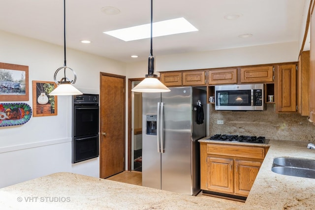 855 Beverly Pl, Lake Forest, IL 60045 - kitchen featuring appliances with stainless steel finishes, a skylight, tasteful backsplash, brown cabinets, and recessed lighting