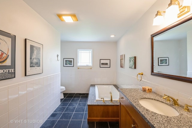 855 Beverly Pl, Lake Forest, IL 60045 - full bathroom with tile patterned flooring, vanity, tile walls, a garden tub, and a wainscoted wall
