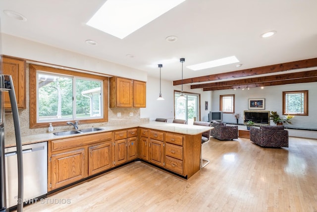 855 Beverly Pl, Lake Forest, IL 60045 - kitchen featuring a skylight, stainless steel dishwasher, beam ceiling, recessed lighting, and light countertops