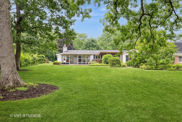 855 Beverly Pl, Lake Forest, IL 60045 - back of property with a sunroom, a chimney, a lawn, and a garage