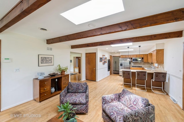 855 Beverly Pl, Lake Forest, IL 60045 - living area featuring a skylight, light wood-type flooring, and beam ceiling