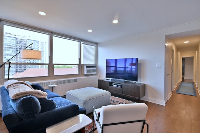 3950 N Lake Shore Dr Unit 810B, Chicago, IL 60613 - living room featuring radiator, wood-type flooring, cooling unit, and recessed lighting