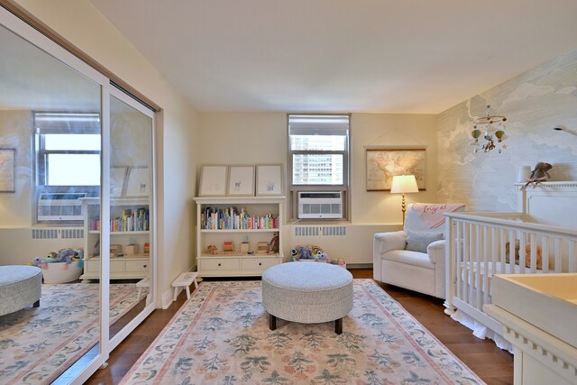 3950 N Lake Shore Dr Unit 810B, Chicago, IL 60613 - bedroom with radiator heating unit, dark wood-style floors, and cooling unit