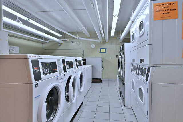 3950 N Lake Shore Dr Unit 810B, Chicago, IL 60613 - community laundry with estacked washer and dryer, washer and clothes dryer, and light tile patterned flooring