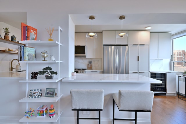 3950 N Lake Shore Dr Unit 810B, Chicago, IL 60613 - kitchen featuring wine cooler, appliances with stainless steel finishes, open shelves, and white cabinetry