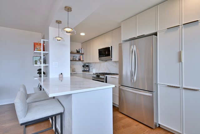 3950 N Lake Shore Dr Unit 810B, Chicago, IL 60613 - kitchen with stainless steel appliances, open shelves, light wood-style flooring, a kitchen breakfast bar, and recessed lighting