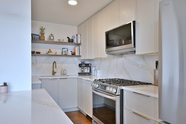 3950 N Lake Shore Dr Unit 810B, Chicago, IL 60613 - kitchen featuring stainless steel appliances, decorative backsplash, and white cabinets