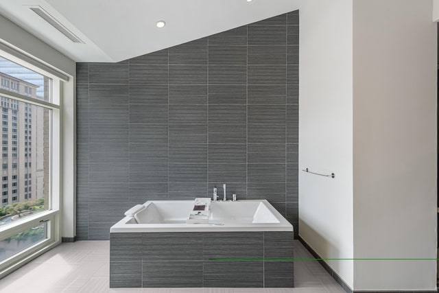 33 W Ontario St Unit Th5, Chicago, IL 60654 - full bath featuring tile walls, a bath, and tile patterned flooring