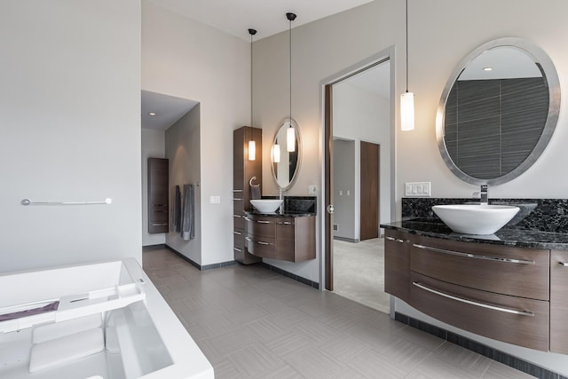 33 W Ontario St Unit Th5, Chicago, IL 60654 - bathroom with two vanities, a towering ceiling, and a bathtub