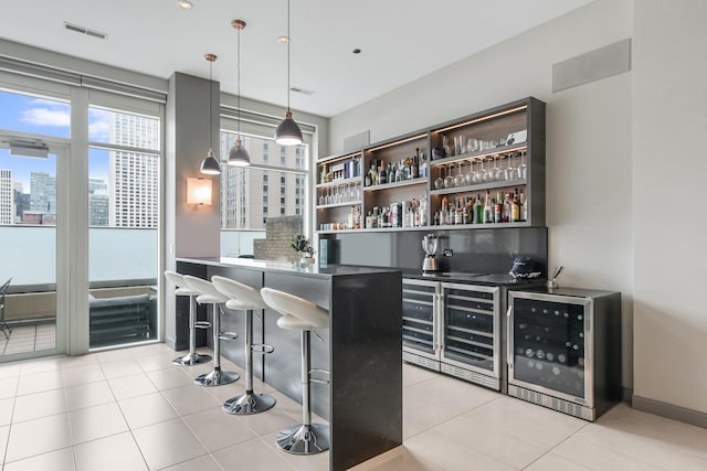 33 W Ontario St Unit Th5, Chicago, IL 60654 - indoor wet bar featuring wine cooler, light tile patterned floors, a view of city, and hanging light fixtures