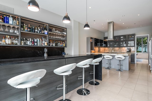 33 W Ontario St Unit Th5, Chicago, IL 60654 - indoor bar featuring island range hood, decorative backsplash, light tile patterned flooring, recessed lighting, and high end refrigerator