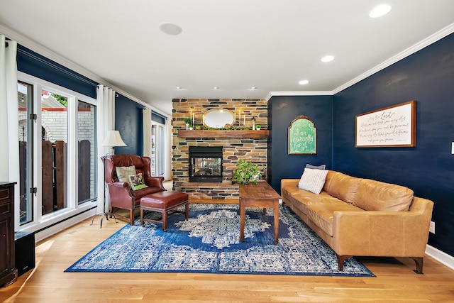 1444 Guildford Dr, Bourbonnais, IL 60914 - living room with ornamental molding, wood finished floors, a stone fireplace, a baseboard heating unit, and recessed lighting